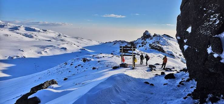 Hikers ascending Mount Kilimanjaro along the steep Umbwe Route with Soraka Tours