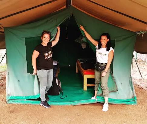Traditional adventure camping tents pitched in a secure wilderness public campsite